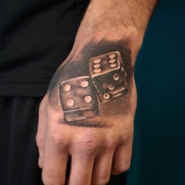 Two dices hand tattoo
