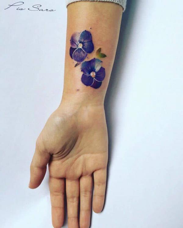 Two violet flowers on the wrist