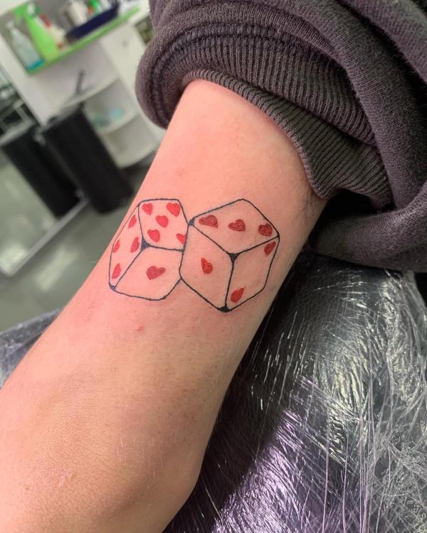 Two white dices with red hearts tattoo