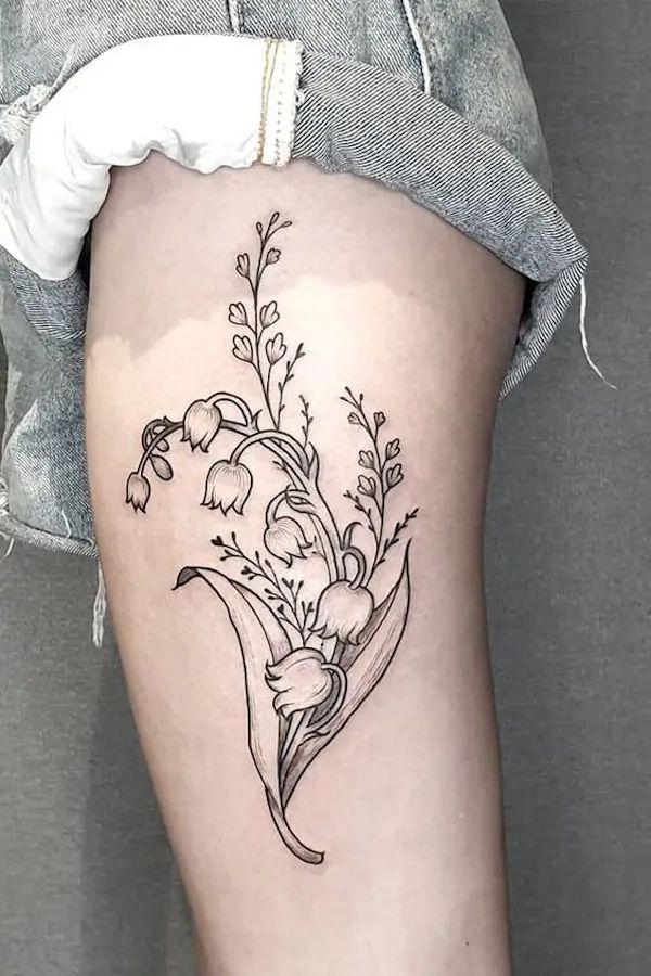 Upper arm tattoo of lily of the valley