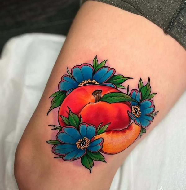 Vibrant sliced peach thigh tattoo
