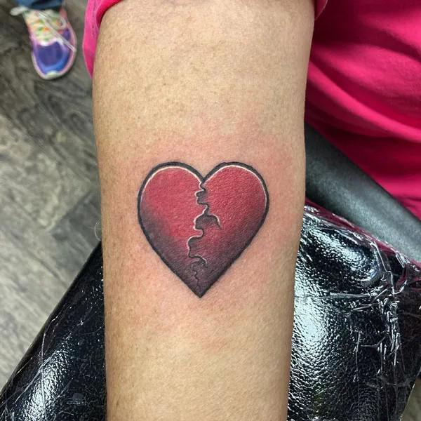 Vintage broken heart tattoo on arm