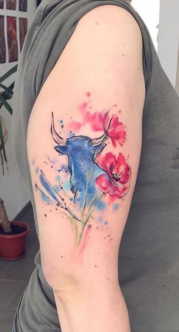 Watercolor Bull and flower upper arm tattoo