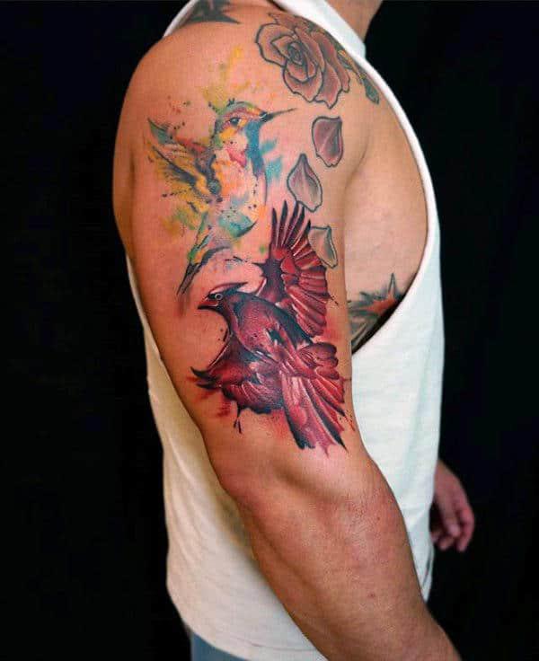 Watercolor cardinal and hummingbird tattoo on upper arm 1