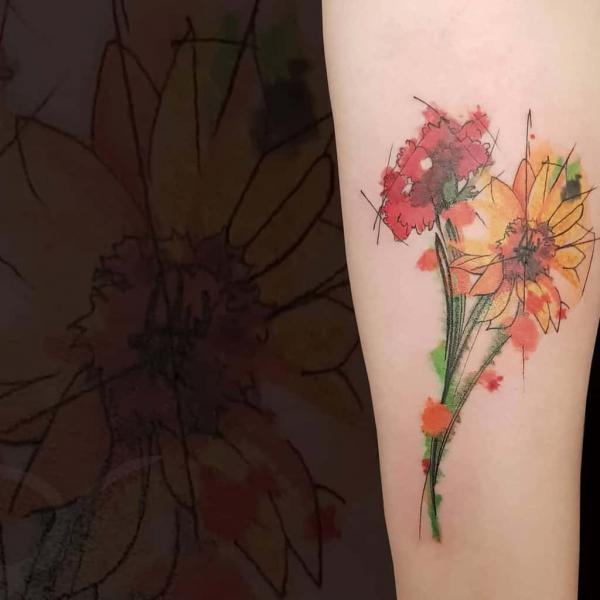 Watercolor carnation and daisy tattoo