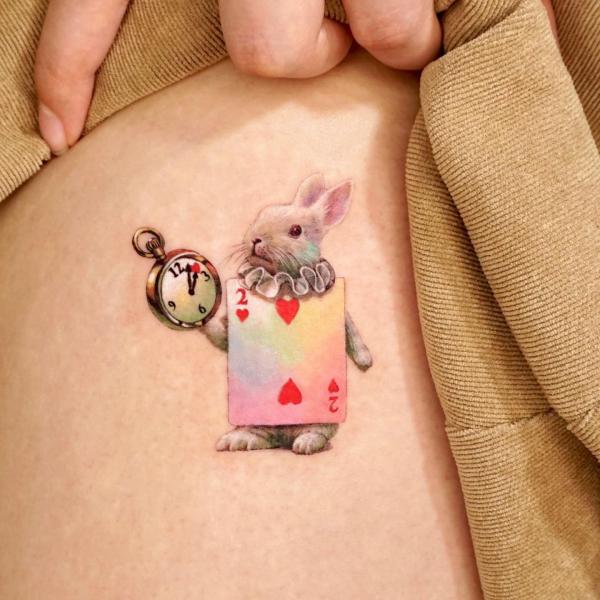 White rabbit with card and clock tattoo