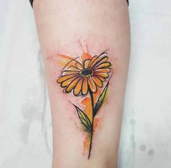 Yellow watercolor daisy tattoo