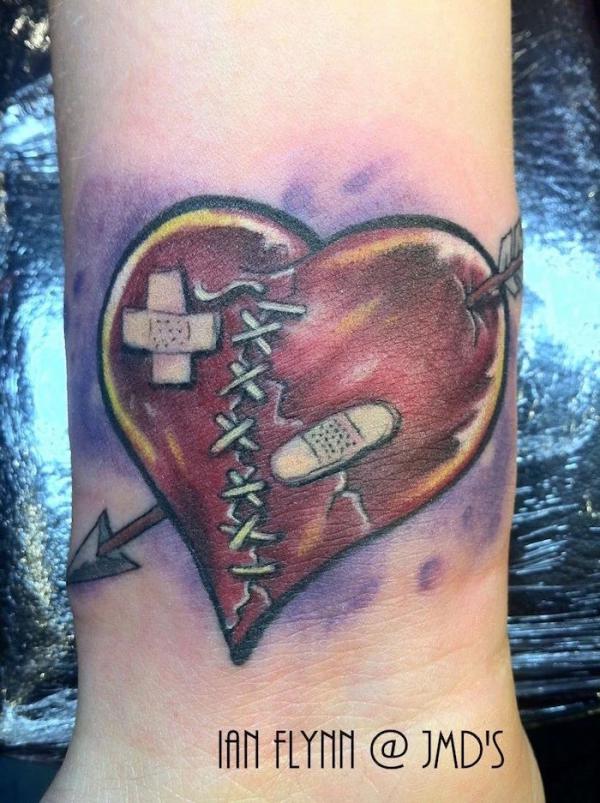 broken heart with arrow through it tattoo
