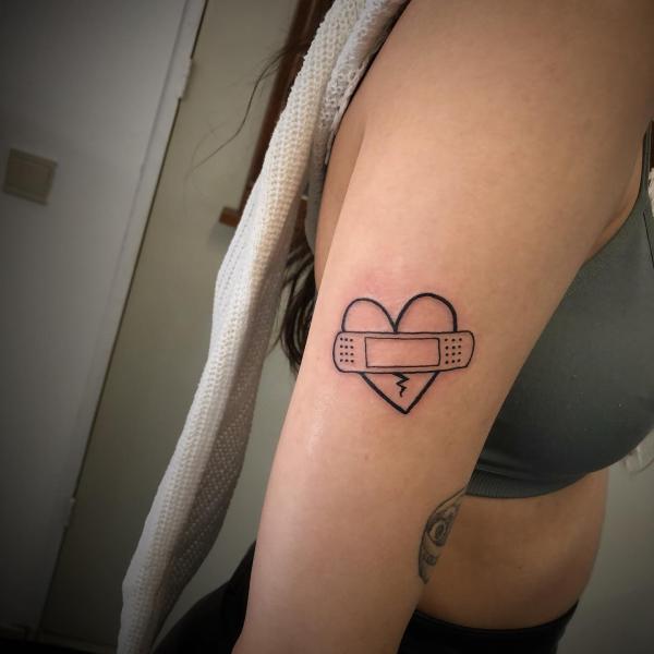 broken heart with bandaid line work tattoo