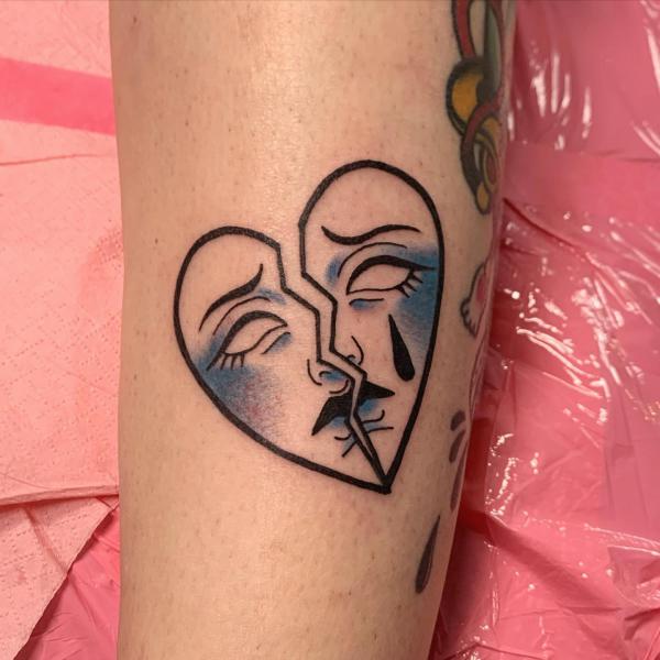 broken heart with face tattoo