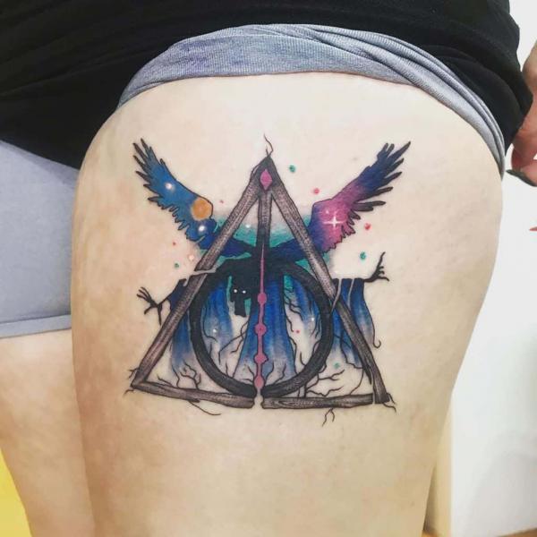 colored deathly hallows with Thestrals thigh tattoo