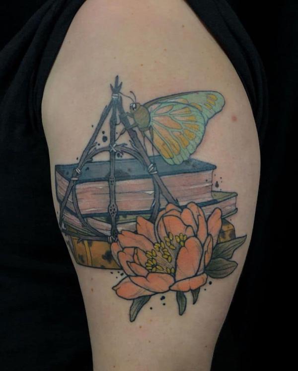 deathly hallows and books with butterfly and flowers tattoo