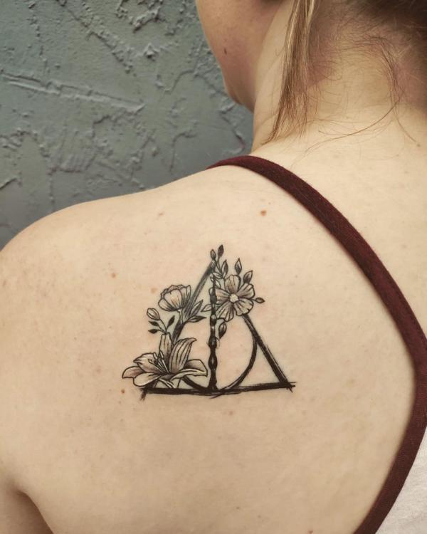 deathly hallows and flowers shoulder blade tattoo