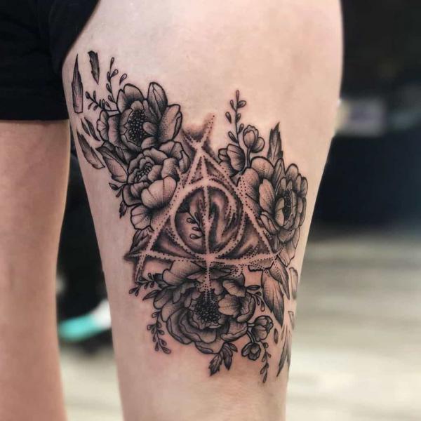 deathly hallows and flowers thigh tattoo
