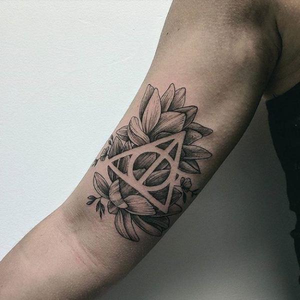deathly hallows and lotus bicep tattoo