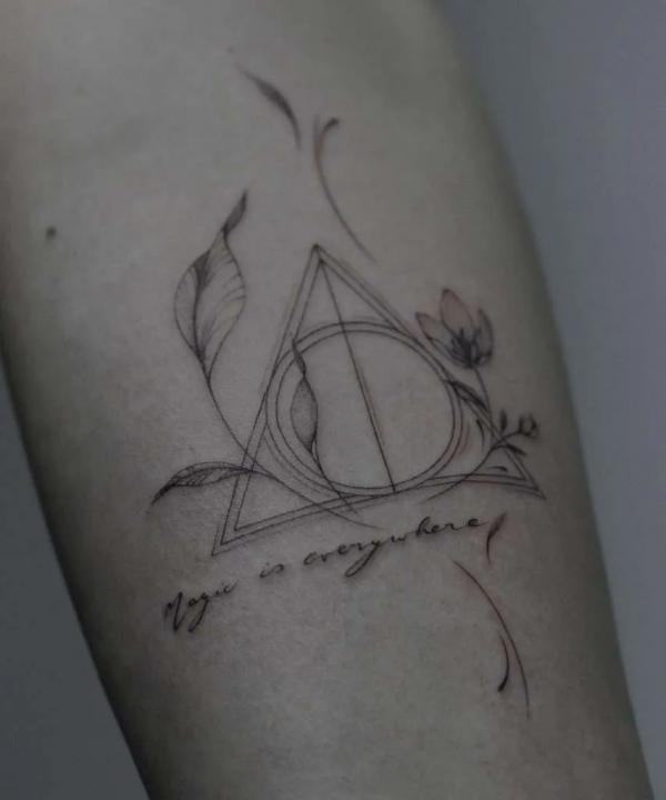 deathly hallows with vine and flowers tattoo with quote Magic is everything