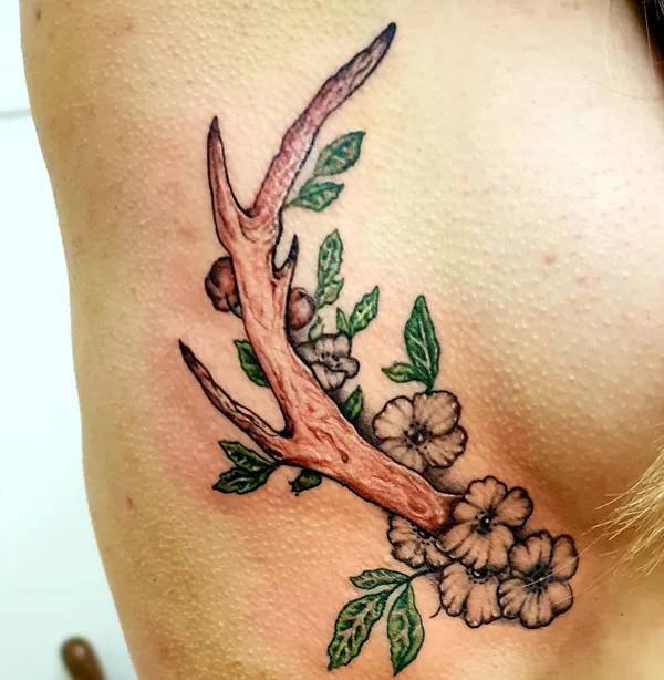 deer antler with flowers side boob tattoo