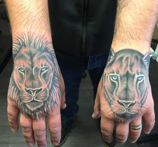 lion and lioness hand tattoo