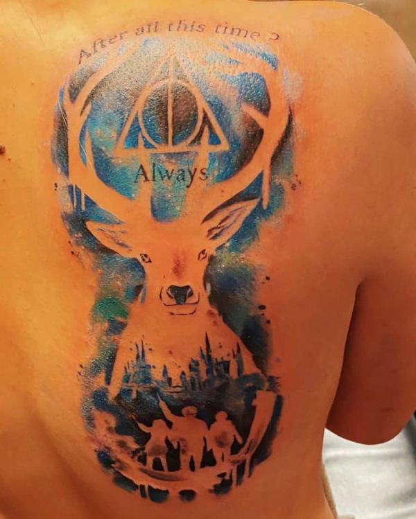 negative space patronus stag with deathly hallows back tattoo