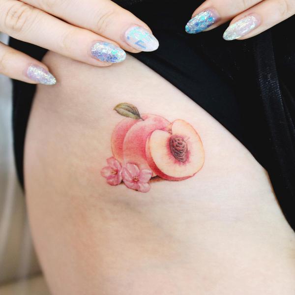 sliced pink peach hip tattoo