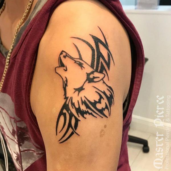 tribal wolf tattoo on upper arm
