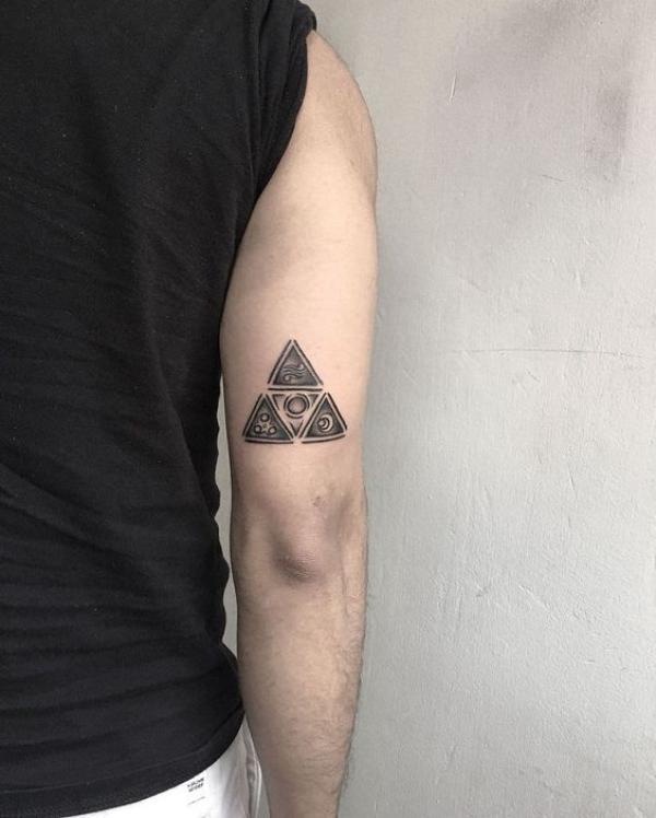 triforce and deathly hallows tattoo above elbow