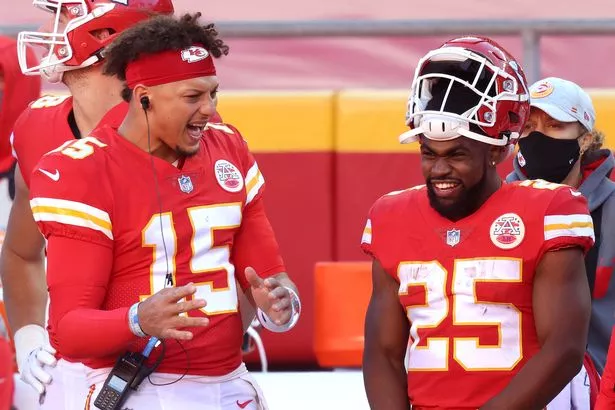 Patrick Mahomes #15 of the Kansas City Chiefs speaks with Clyde Edwards-Helaire #25 on the sidelines during their NFL game against the New York Jets at Arrowhead Stadium on November 01, 2020 in Kansas City, Missouri