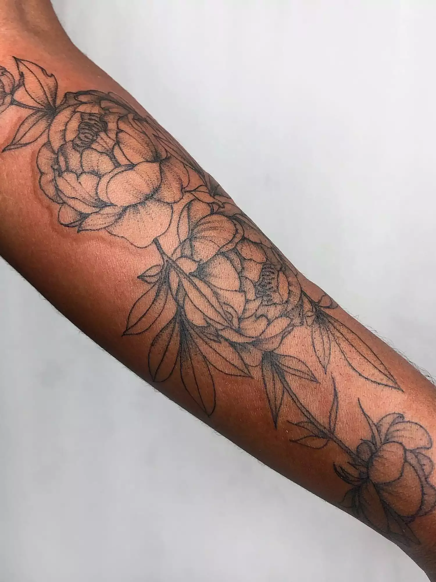 forearm with flower tattoo