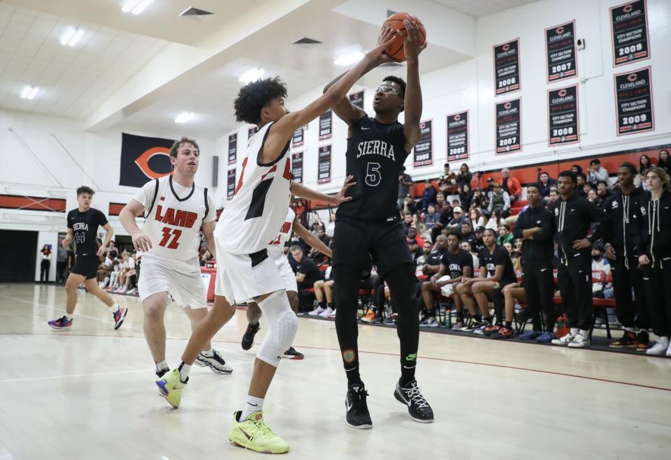 Sierra Canyon's Bryce James attempts a shot over Cleveland's Jacob Mathis during a game last November in Reseda.