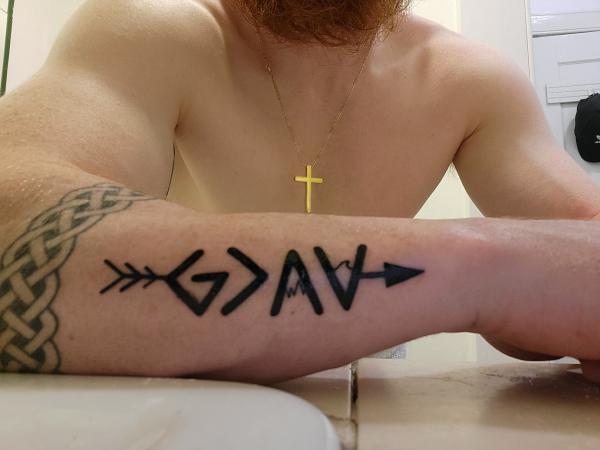 Arrow through god is greater than the highs and lows tattoo forearm