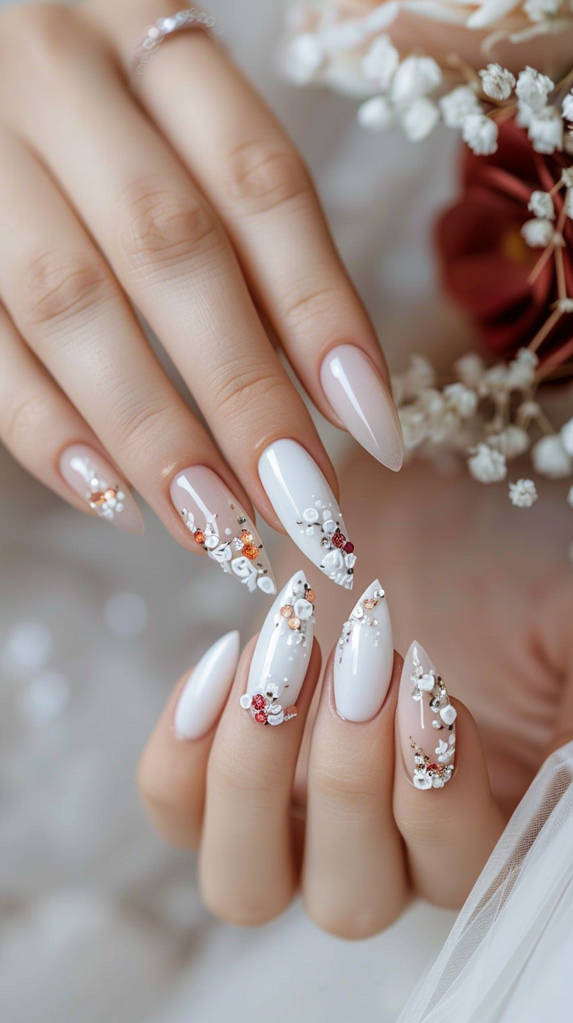 Almond nails with a white base, detailed with rose gold and silver accents, and embellished with tiny crystals for an exquisite bridal finish.