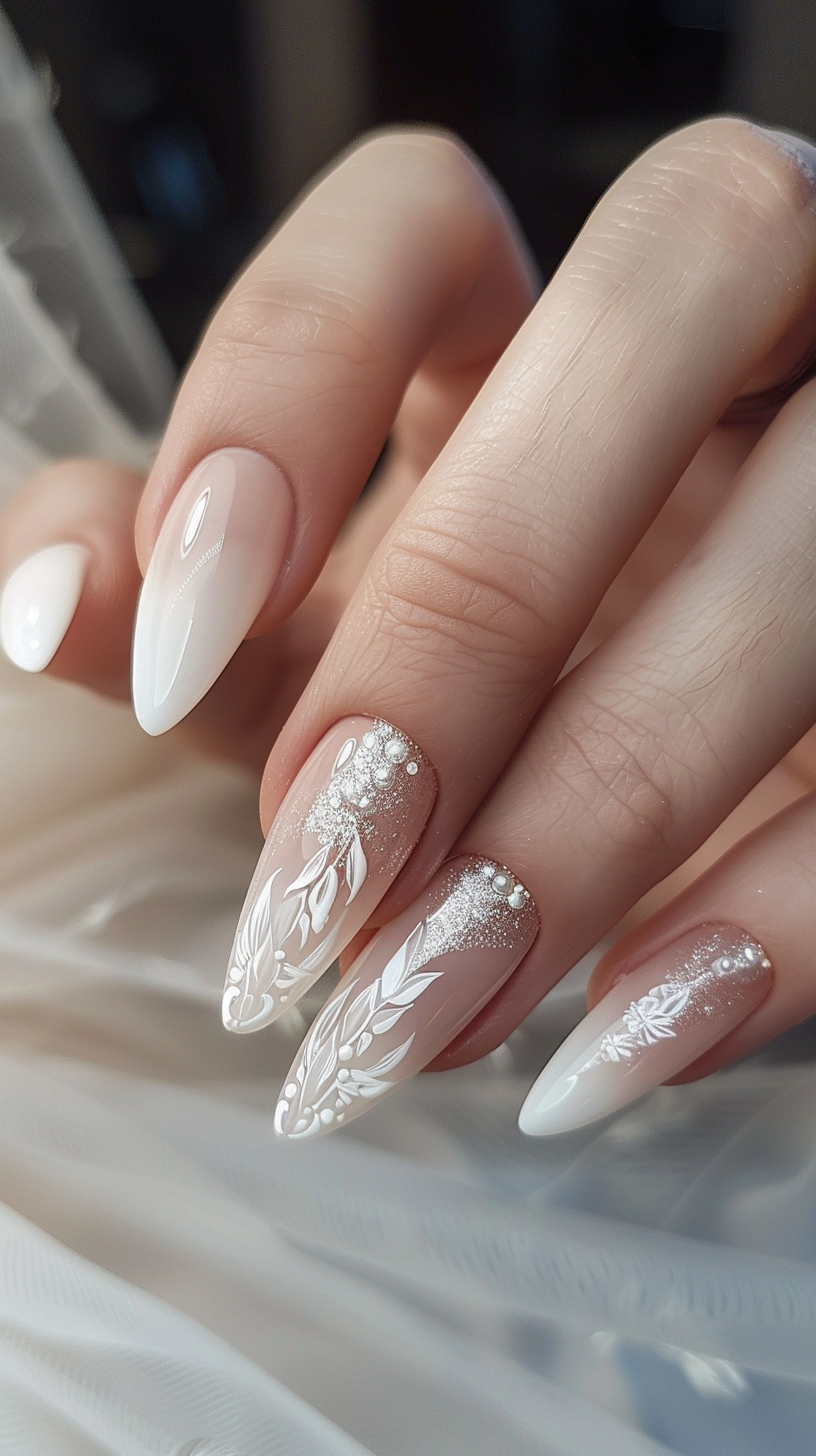The bridal nails showcase an ethereal design featuring delicate white leaves and vines hand-painted on a sheer nude base. The artwork gradually intensifies with fine silver glitter towards the tips, creating a dreamy and romantic look that complements the bride's special day.