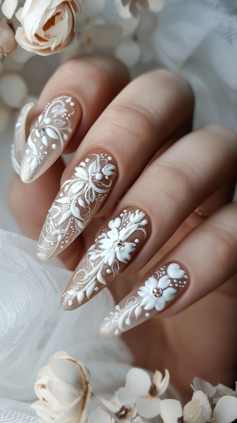 The nude-colored nails are adorned with intricate white lace patterns, pearls, crystals, and delicate 3D floral embellishments, creating an elegant and dreamy look perfect for a bride on her wedding day.
