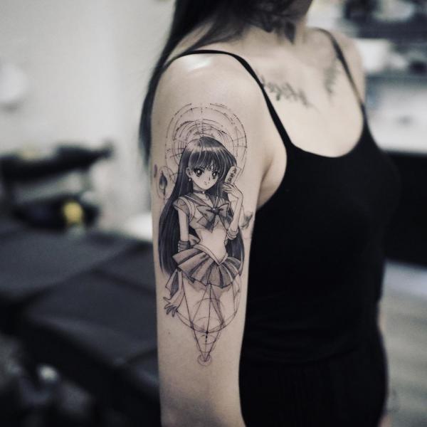 Black and white sailor Mars tattoo on upper arm