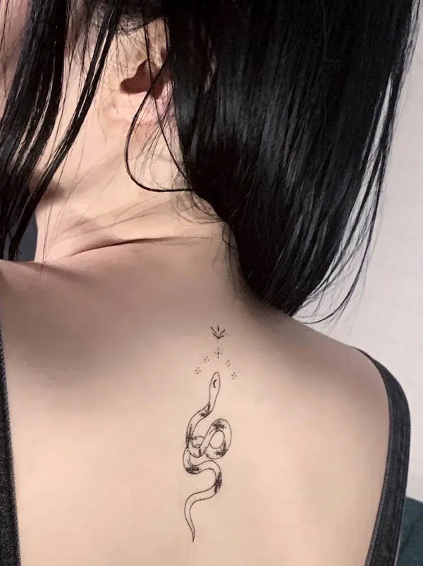 Black snake back tattoo by @e.hyang_.tattoo