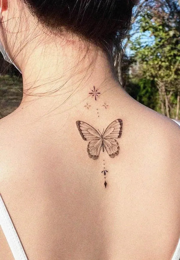 Black and grey simple butterfly back tattoo by @e.hyang_.tattoo