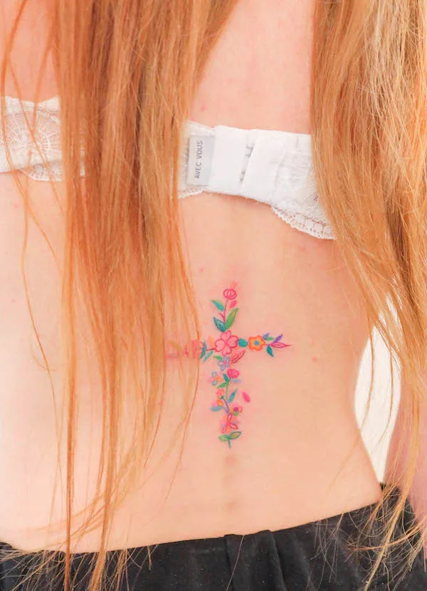 Girly floral cross tattoo on the lower back by @sisi.lovelove