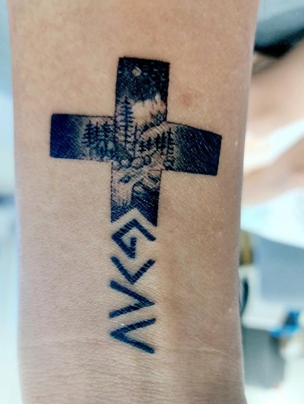 Forest cross and god is greater than the highs and lows forearm tattoo