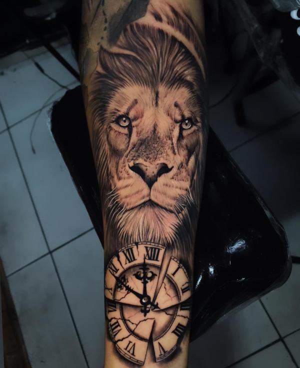 Lion king and clock forearm tattoo