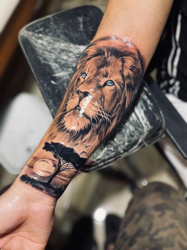 Lion king and full moon tattoo on forearm