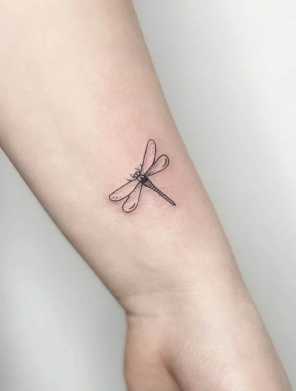 Minimalist dragonfly wrist tattoo by @frau.ines_