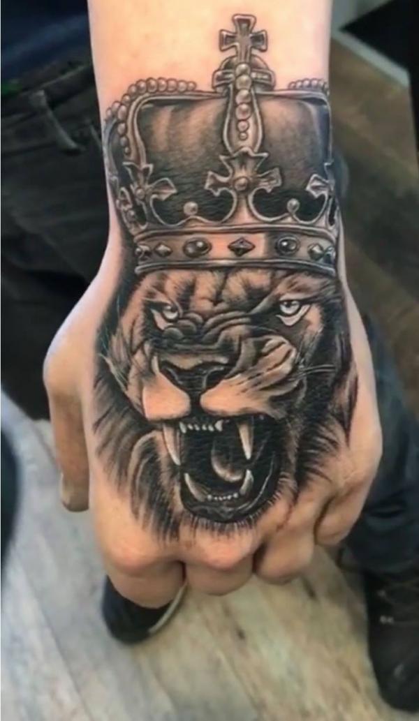 Realistic Lion king with crown tattoo hand