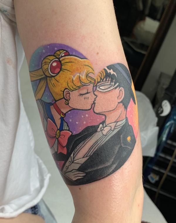 Sailor Moon and Tuxedo Mask tattoo on upper arm