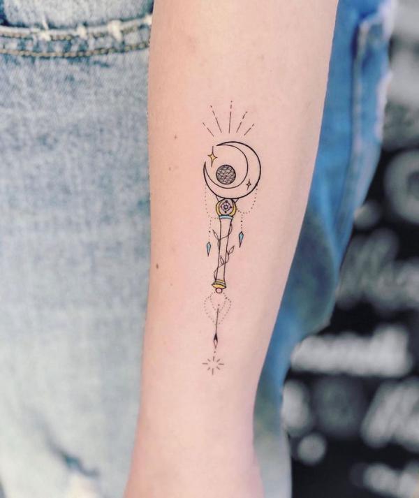 Small sailor moon wand tattoo on forearm