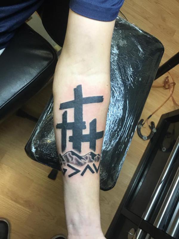 Three cross and god is greater than the highs and lows with mountain tattoo forearm