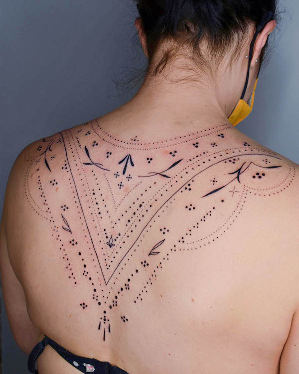 Upper back ornamental tattoo by @k_inx