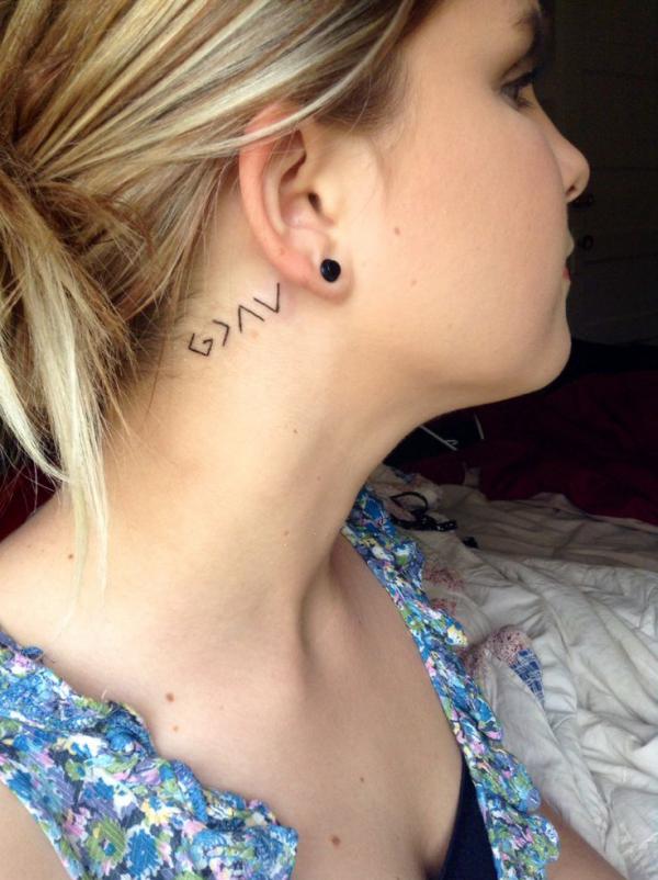 god is greater than the highs and lows tattoo behind the ear