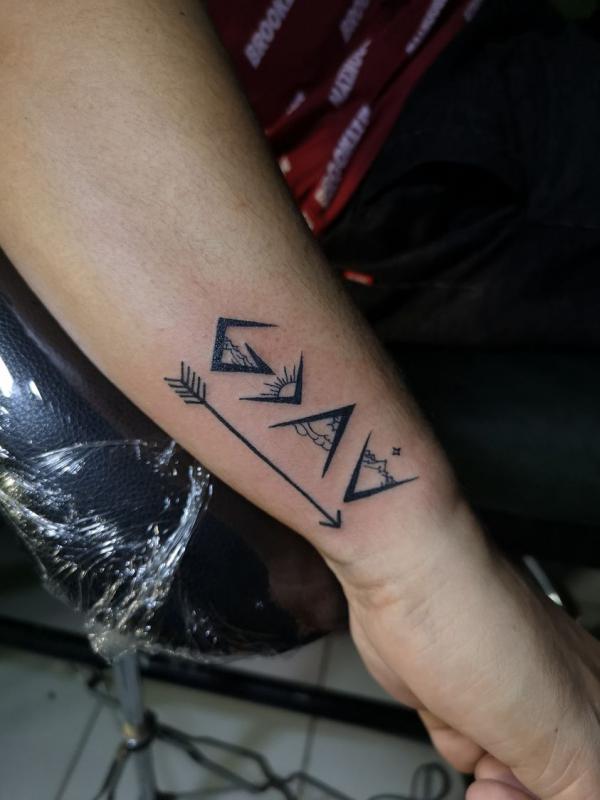 god is greater than the highs and lows with arrow tattoo forearm