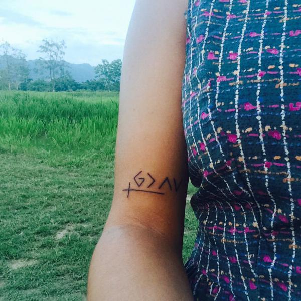 god is greater than the highs and lows with cross bicep tattoo