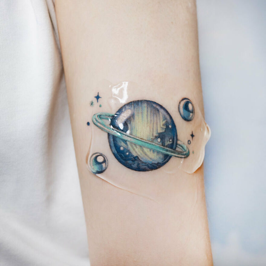 Saturn and soap bubbles arm tattoo